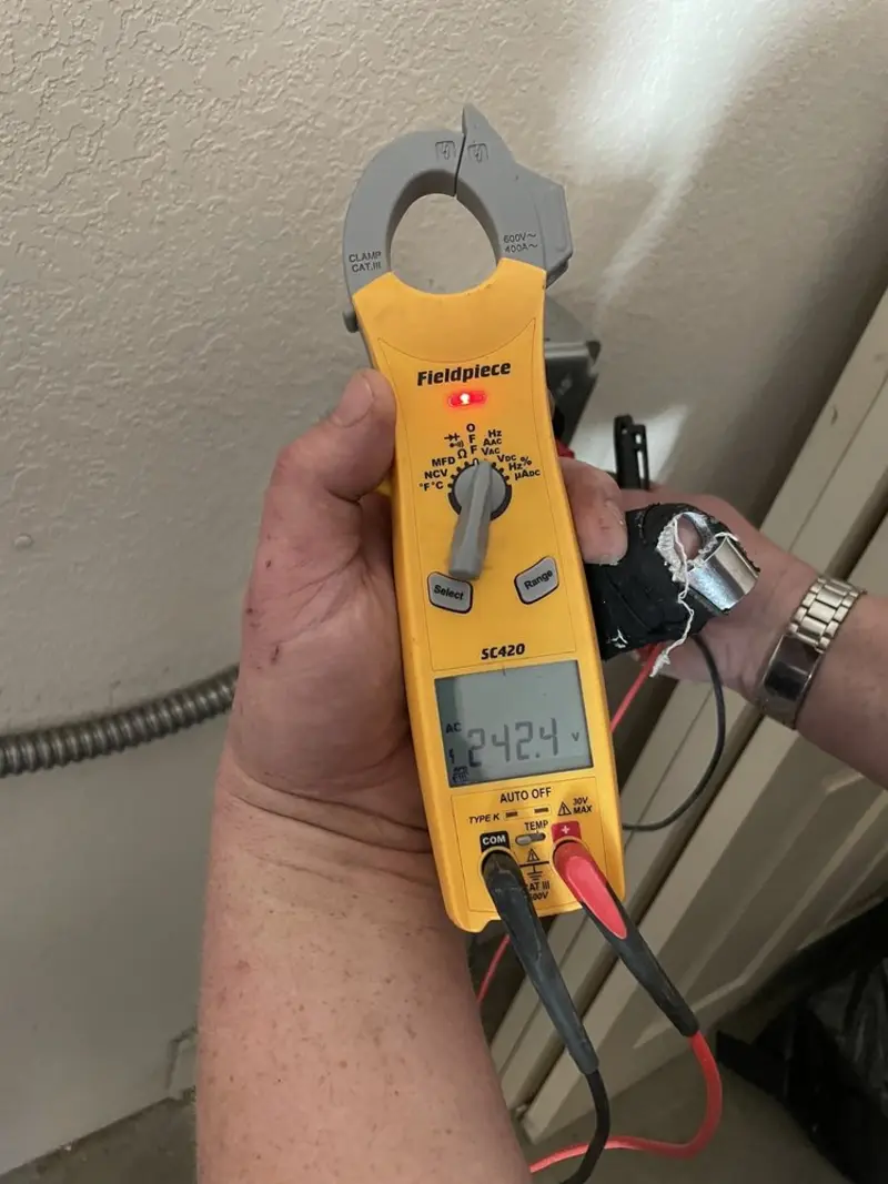 Voltage testing with clamp meter during Outlet Installation in Amherst